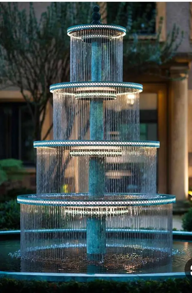 Tiered fountain with water curtains and lighting