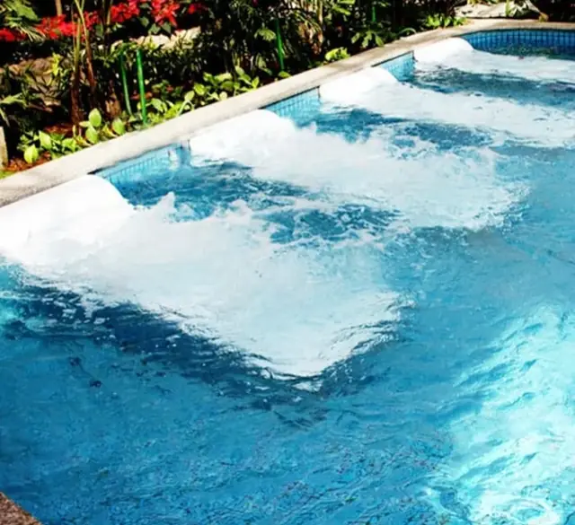 Massage loungers in an outdoor leisure pool
