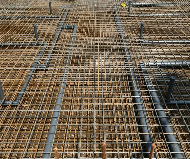 Reinforcement mesh with embedded pipe runs