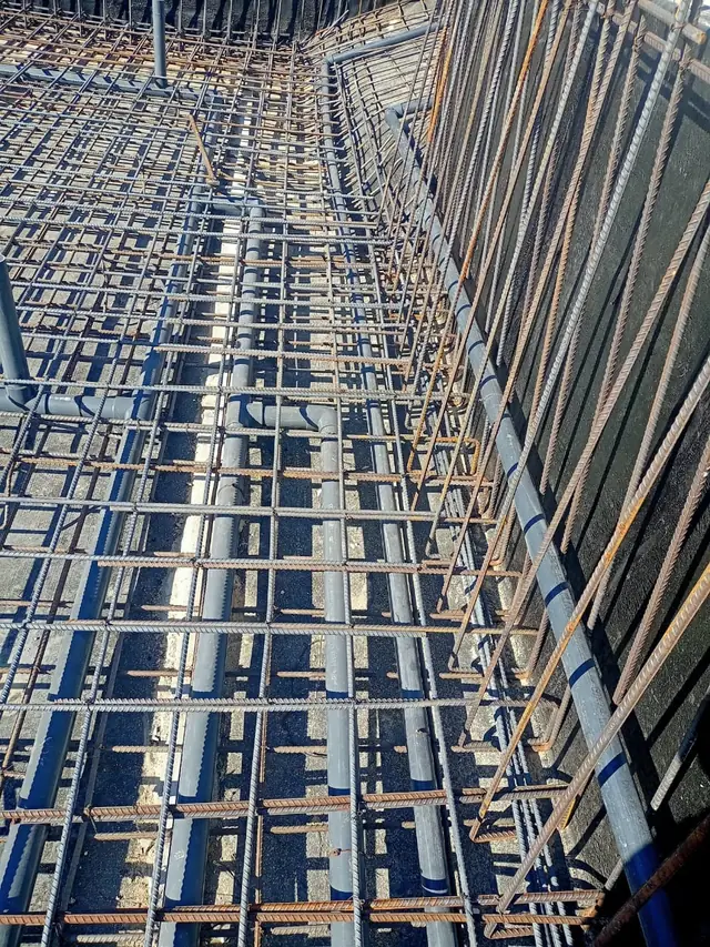 Rebar and pipework along the full basin length