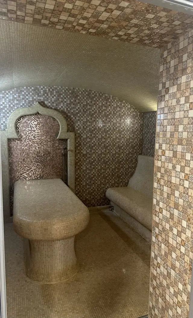 Hammam with stone benches and Moroccan arch