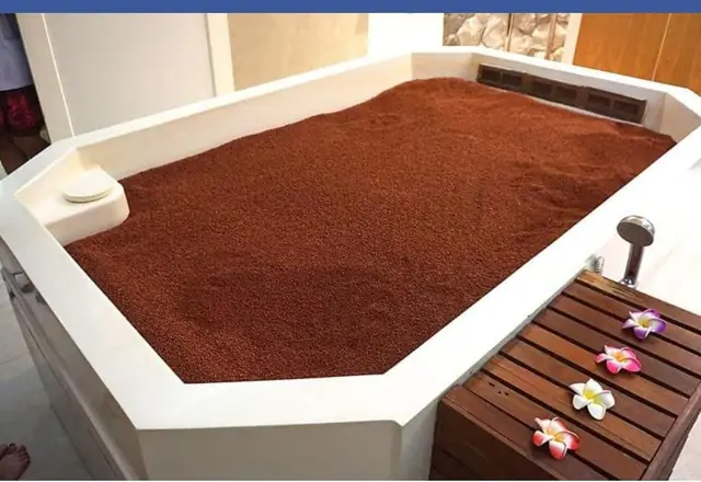 Volcanic-sand therapy bed with softened edges